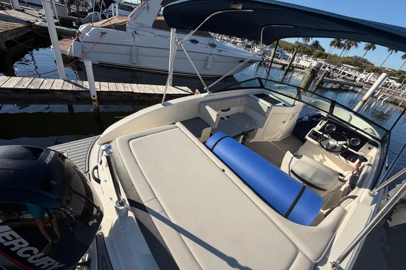 Slide: The Image of 2022 Sea Ray 19 SPX OB boat docked, featuring spacious seating and a Mercury outboard engine. - 8