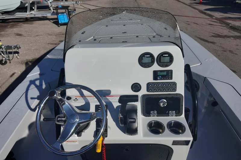 Slide: The Image of 2026 Blazer 675 Ultimate Bay boat dashboard with steering wheel and controls. - 13