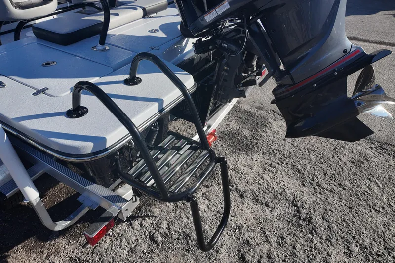 Slide: The Image of 2026 Blazer 675 Ultimate Bay boat with motor and boarding ladder. - 19