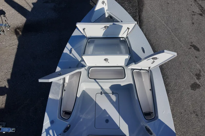 Slide: The Image of 2026 Blazer 675 Ultimate Bay boat with open storage compartments, top view. - 9