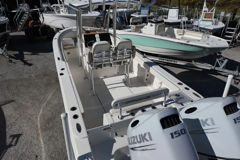 Slide: The Image of 2025 Bulls Bay 255 CC boat with dual Suzuki 150 engines in a marina setting. - 6