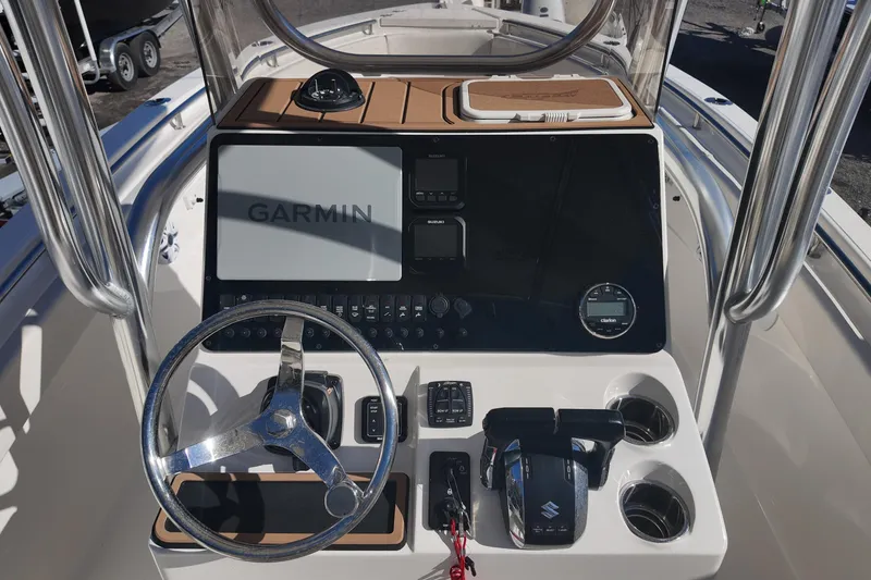 Slide: The Image of 2025 Bulls Bay 255 CC boat console with Garmin navigation and Suzuki controls. - 9