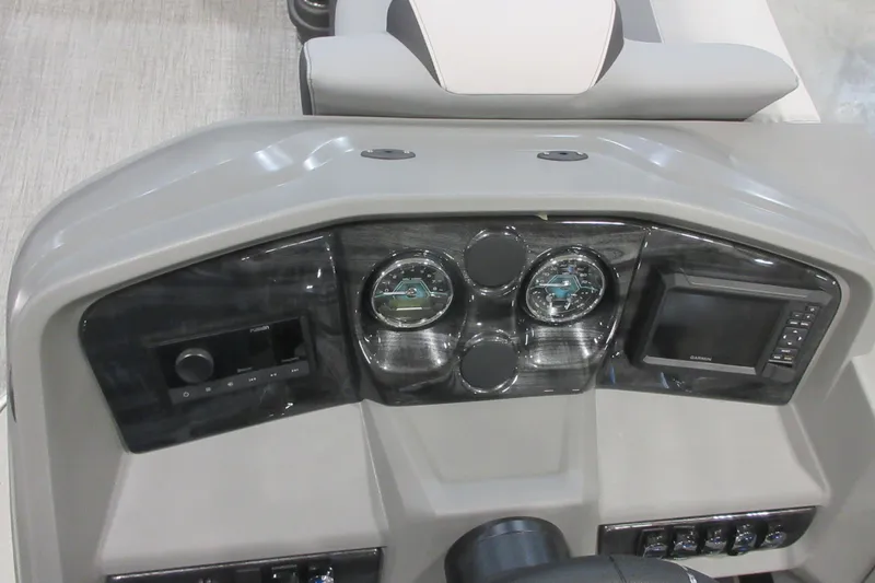 Slide: The Image of Dashboard of 2026 Tahoe Pontoon 23 LTZ Quad Lounge with gauges and Garmin display. - 100