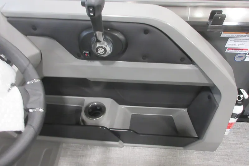 Slide: The Image of 2026 Tahoe Pontoon 23 LTZ Quad Lounge helm with steering wheel and control panel. - 101