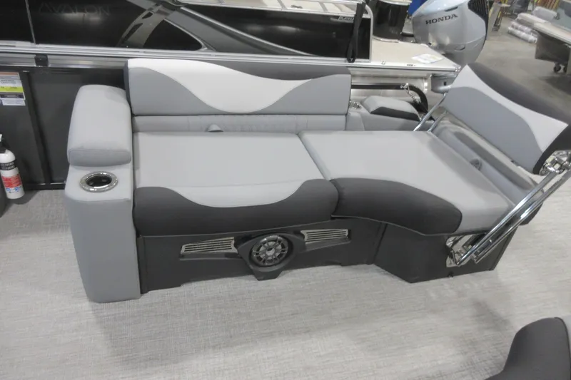 Slide: The Image of 2026 Tahoe Pontoon 23 LTZ Quad Lounge with gray seating and integrated speaker system. - 103