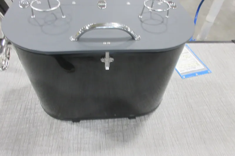 Slide: The Image of 2026 Tahoe Pontoon 23 LTZ Quad Lounge with sleek black storage compartment and cup holders. - 109