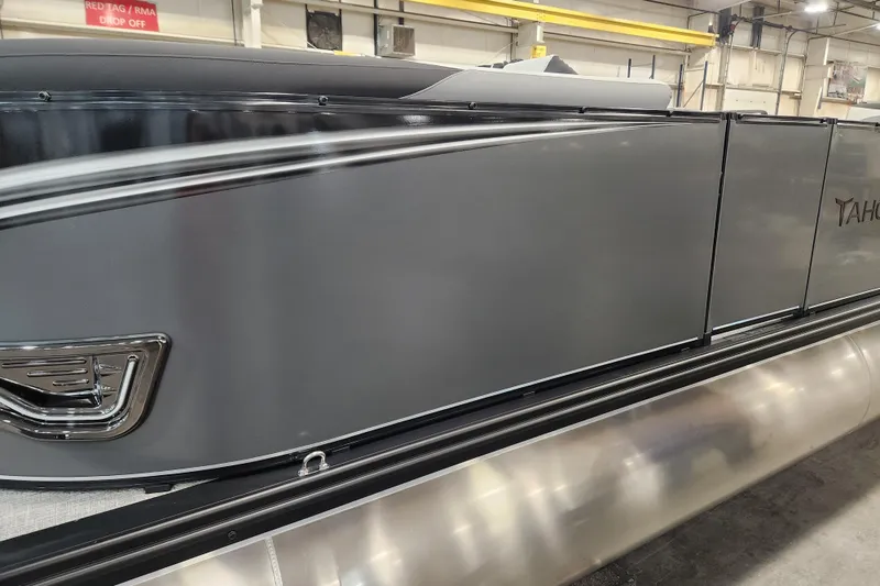 Slide: The Image of 2026 Tahoe Pontoon 23 LTZ Quad Lounge interior with gray seating and built-in speakers. - 17