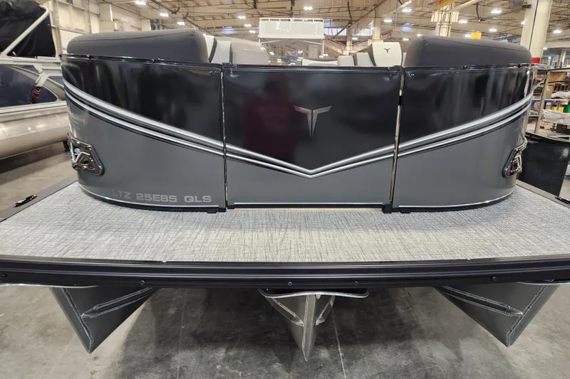 Slide: The Image of 2026 Tahoe Pontoon 23 LTZ Quad Lounge captain's chair and steering wheel, wrapped in protective plastic. - 33