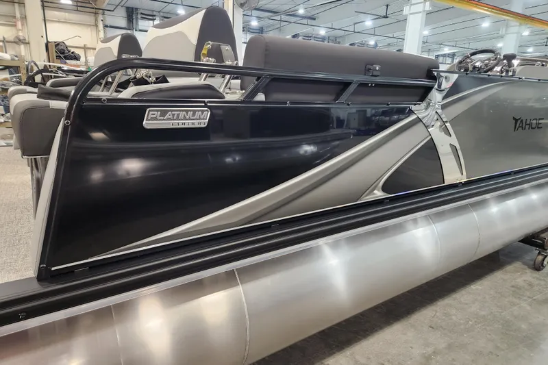 Slide: The Image of 2026 Tahoe Pontoon 23 LTZ Quad Lounge steering console with modern controls and seating. - 35