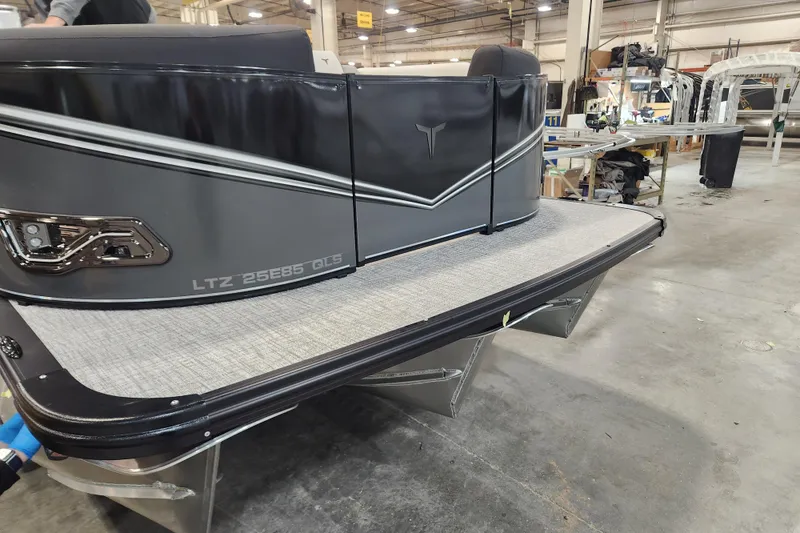 Slide: The Image of 2026 Tahoe Pontoon 23 LTZ Quad Lounge on trailer, parked outdoors. - 4