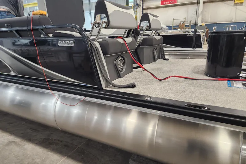 Slide: The Image of 2026 Tahoe Pontoon 23 LTZ Quad Lounge with Mercury engine, parked on trailer. - 6