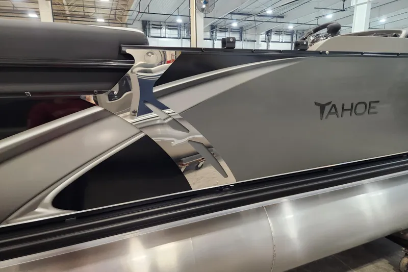 Slide: The Image of 2026 Tahoe Pontoon 23 LTZ Quad Lounge, sleek design in a modern showroom. - 74