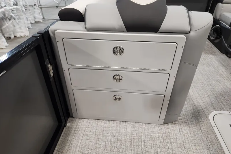 Slide: The Image of 2026 Tahoe Pontoon 23 LTZ Quad Lounge interior storage drawers. - 78