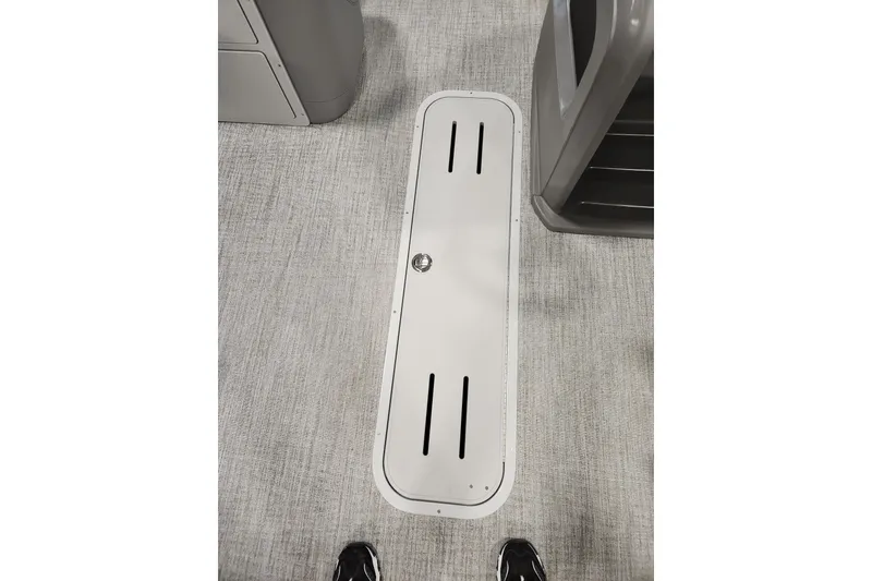 Slide: The Image of Floor hatch on 2026 Tahoe Pontoon 23 LTZ Quad Lounge boat interior. - 79