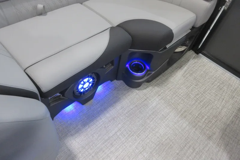 Slide: The Image of 2026 Tahoe Pontoon 23 LTZ Quad Lounge interior with illuminated speaker and cup holder. - 82