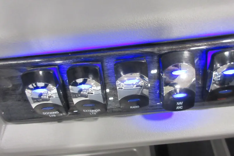 Slide: The Image of Control panel of 2026 Tahoe Pontoon 23 LTZ Quad Lounge with illuminated switches. - 85