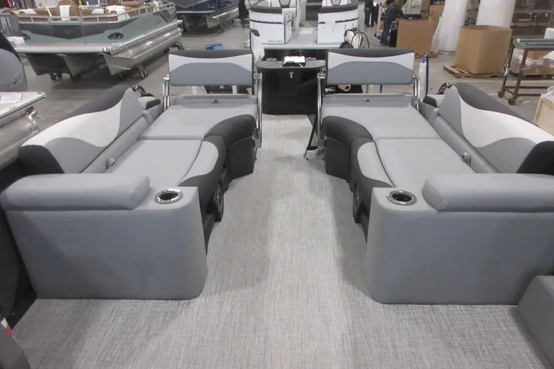 Slide: The Image of 2026 Tahoe Pontoon 23 LTZ Quad Lounge interior with gray seating and cup holders. - 90