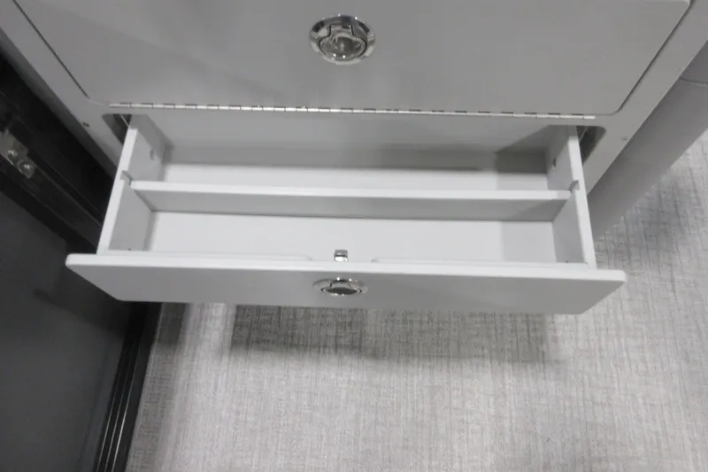 Slide: The Image of Open storage drawer in 2026 Tahoe Pontoon 23 LTZ Quad Lounge boat. - 94