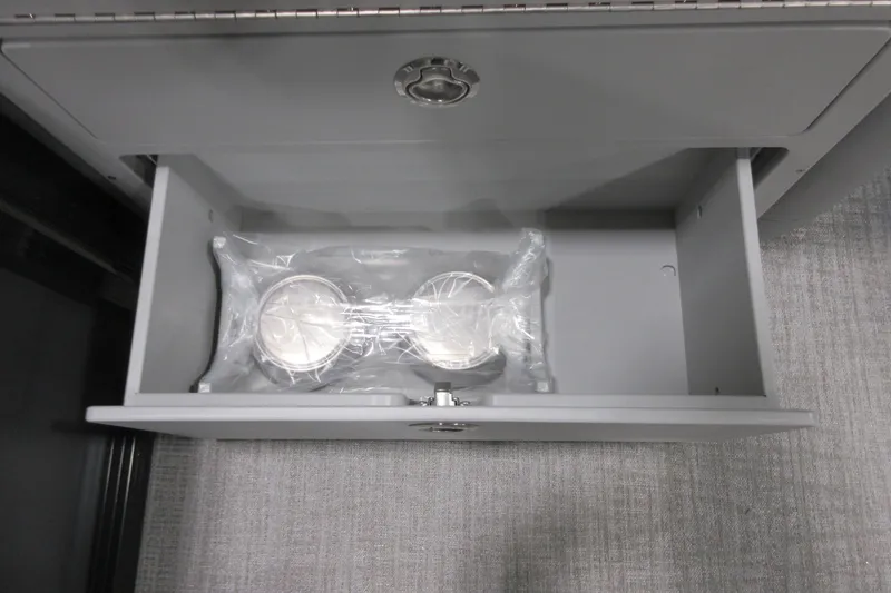 Slide: The Image of Open drawer in 2026 Tahoe Pontoon 23 LTZ Quad Lounge, containing wrapped items. - 95