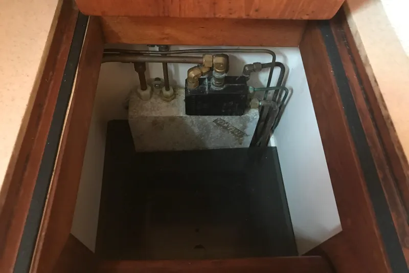 Slide: The Image of Hidden compartment with plumbing and valves in a Passport 456, 1999 model. - 12