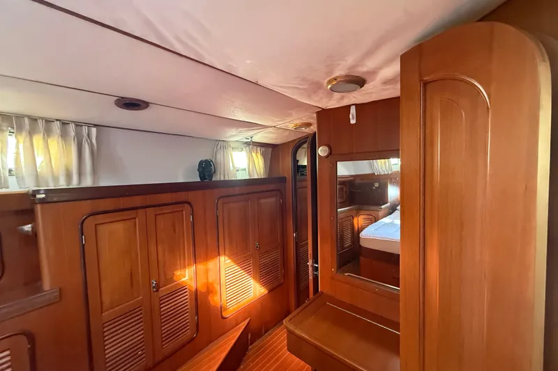 Slide: The Image of Interior of 1999 Passport 456 yacht with wooden cabinetry and cozy sleeping area. - 17