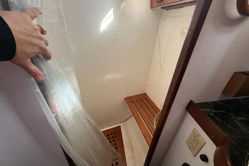 Slide: The Image of Small wooden shower area in a 1999 Passport 456 boat. - 19