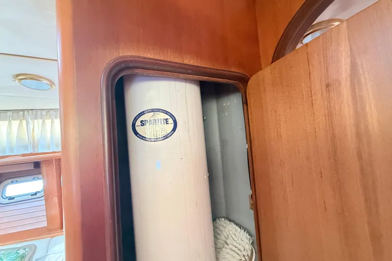 Slide: The Image of Wooden interior of a 1999 Passport 456 yacht with storage compartment. - 27