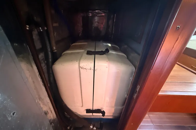 Slide: The Image of Engine compartment of a 1999 Passport 456 yacht, featuring a white engine cover. - 32