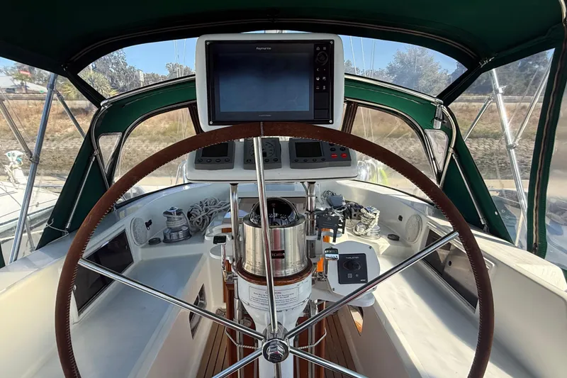 Slide: The Image of Cockpit of 1999 Passport 456 sailboat with steering wheel and navigation equipment. - 34