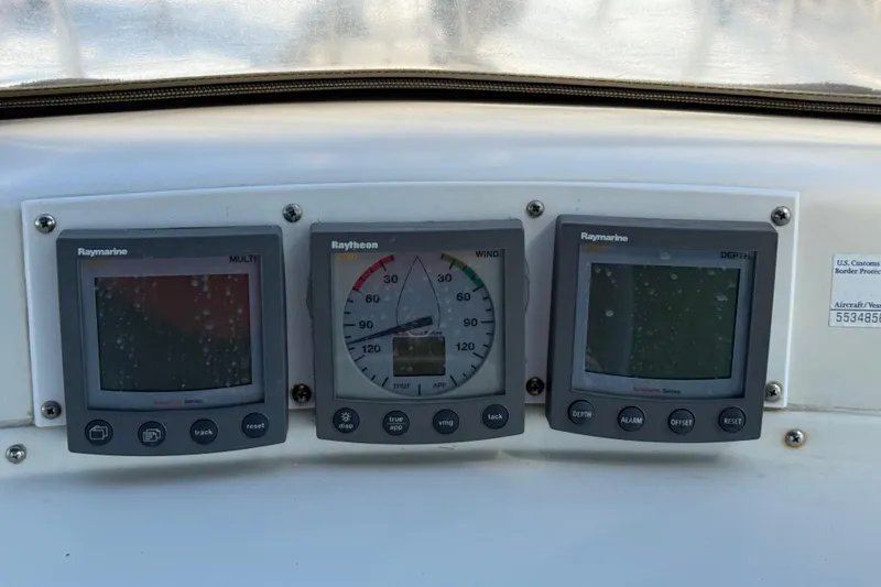 Slide: The Image of Boat dashboard with Raymarine and Raytheon instruments, Passport 456, 1999 model. - 36