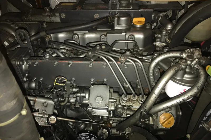 Slide: The Image of Close-up of a 1999 Passport 456 engine with visible components and wiring. - 41