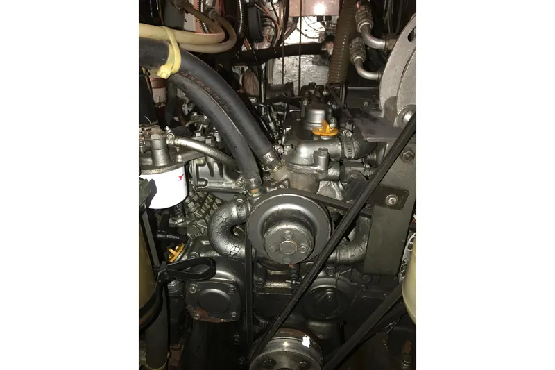 Slide: The Image of Engine of a 1999 Passport 456 model with visible belts and hoses. - 42