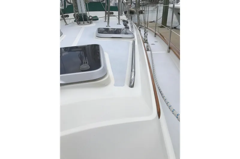 Slide: The Image of Deck view of a 1999 Passport 456 sailboat, featuring hatches and rigging. - 46