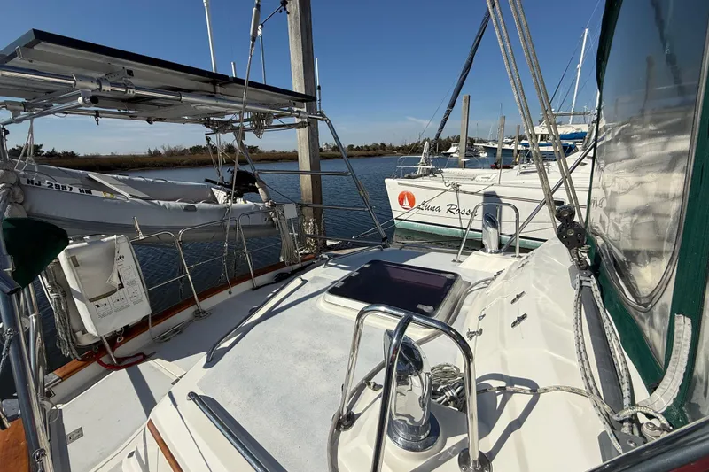 Slide: The Image of Sailboat docked at marina, featuring Passport 456 model, sunny day, clear blue sky. - 51