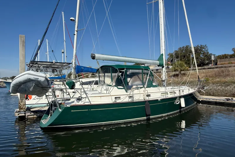 Slide: The Image of Sailboat docked in marina, Passport 456 model, 1999, with green hull and canopy. - 55