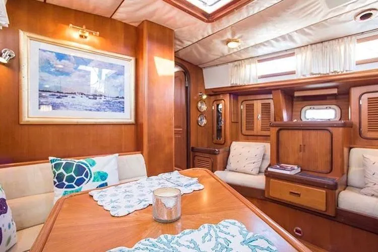 Slide: The Image of Luxurious interior of a 1999 Passport 456 yacht with elegant wood finishes and cozy seating. - 9