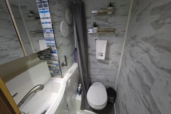 Slide: The Image of Compact bathroom in 2011 Lagoon 400 yacht with modern fixtures and decorative tiles. - 13