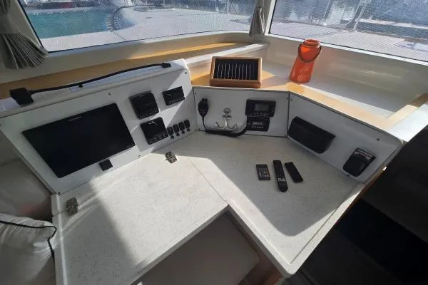 Slide: The Image of Cockpit of 2011 Lagoon 400 catamaran with navigation equipment and controls. - 14