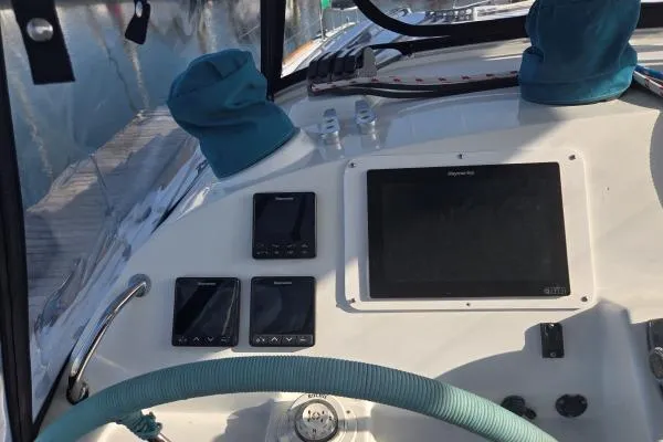Slide: The Image of Cockpit of 2011 Lagoon 400 catamaran with navigation instruments and steering wheel. - 17
