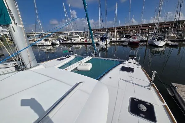 Slide: The Image of 2011 Lagoon 400 catamaran docked at marina with clear blue sky. - 21