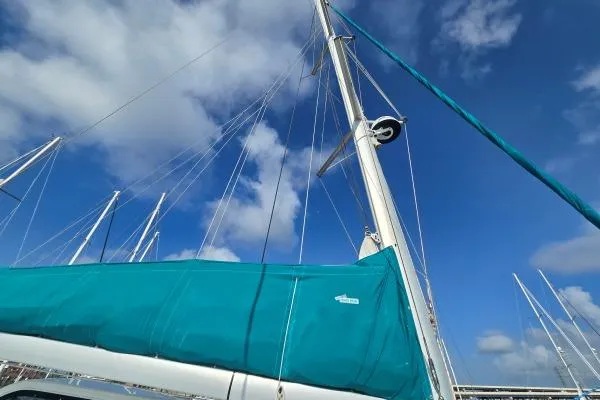 Slide: The Image of Sailboat mast and sail of 2011 Lagoon 400 against a blue sky with clouds. - 23