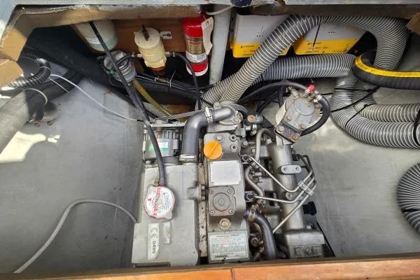 Slide: The Image of Engine compartment of a 2011 Lagoon 400 catamaran, featuring mechanical components and wiring. - 28