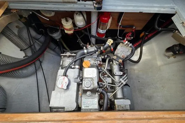 Slide: The Image of Engine compartment of a 2011 Lagoon 400 catamaran, featuring mechanical components and hoses. - 29
