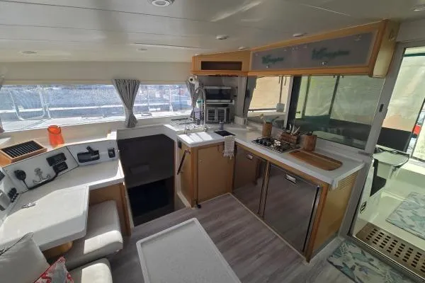 Slide: The Image of Interior of 2011 Lagoon 400 catamaran with modern kitchen and navigation area. - 3