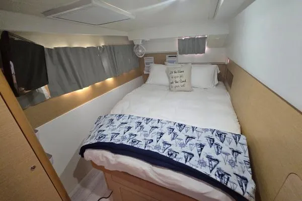 Slide: The Image of Cozy bedroom in 2011 Lagoon 400 yacht with nautical-themed bedding. - 6