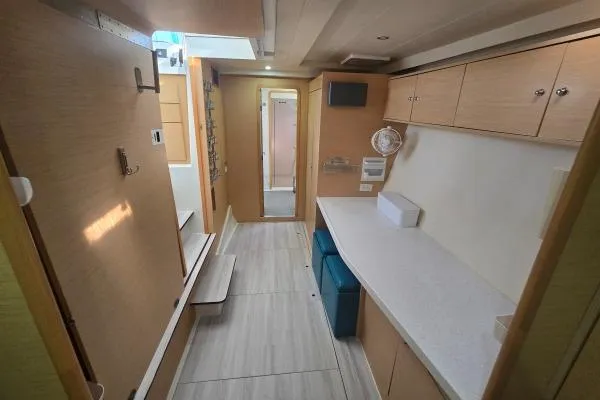 Slide: The Image of Interior of 2011 Lagoon 400 catamaran with modern wood cabinetry and sleek design. - 7