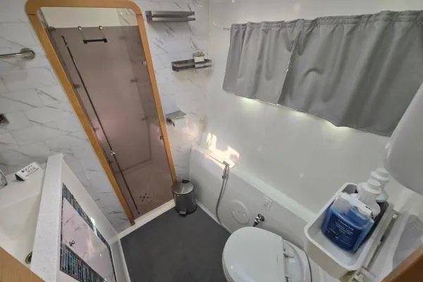Slide: The Image of Bathroom interior of 2011 Lagoon 400 catamaran with shower, toilet, and modern fixtures. - 9
