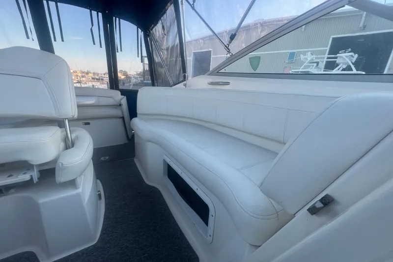 Slide: The Image of 2008 Bayliner 245 Cruiser interior with white seating and clear windows. - 13
