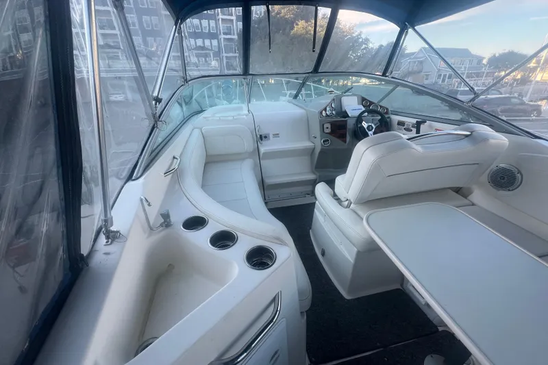 Slide: The Image of 2008 Bayliner 245 Cruiser interior with seating, steering wheel, and cup holders. - 2