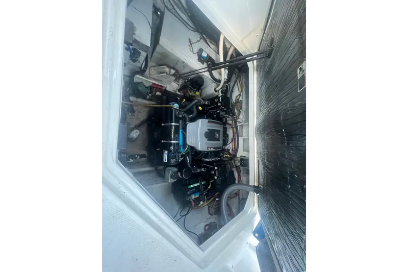 Slide: The Image of Engine compartment of a 2008 Bayliner 245 Cruiser boat, showcasing mechanical components. - 22